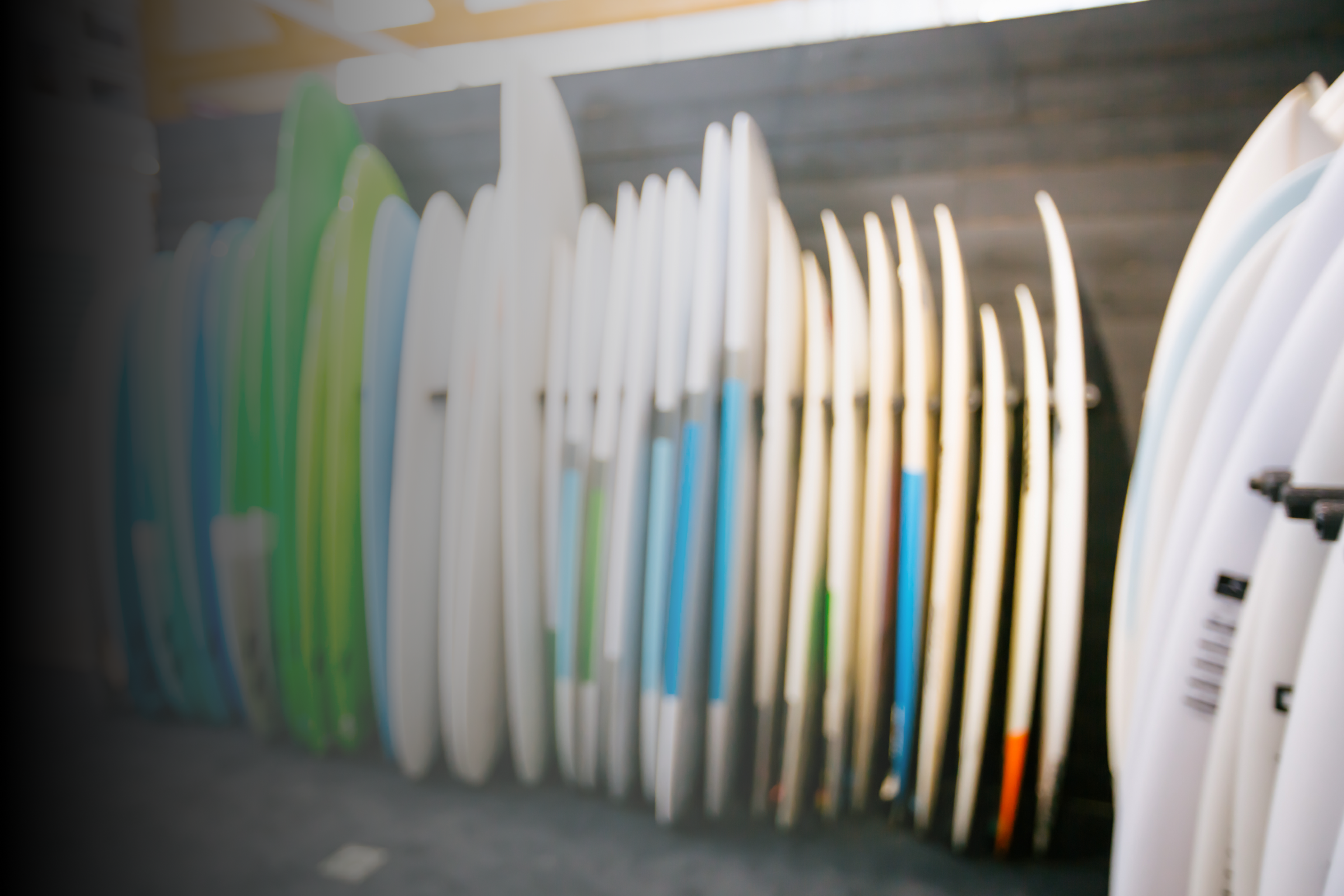 Retail surfboards lined against the wall in shop 