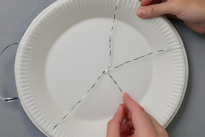 threading string through paper plate