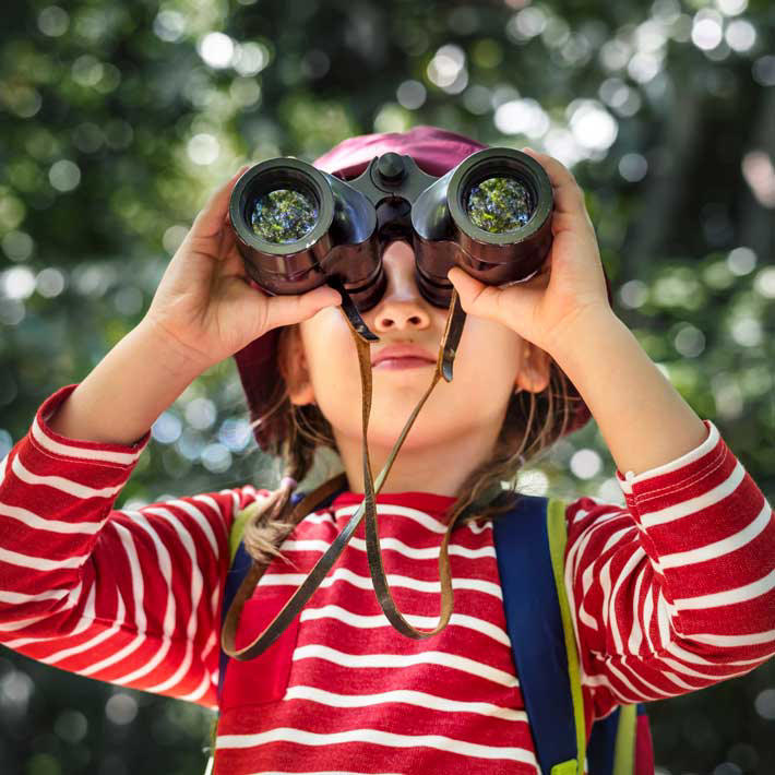 little-girl-using-binoculars-forest.jpg