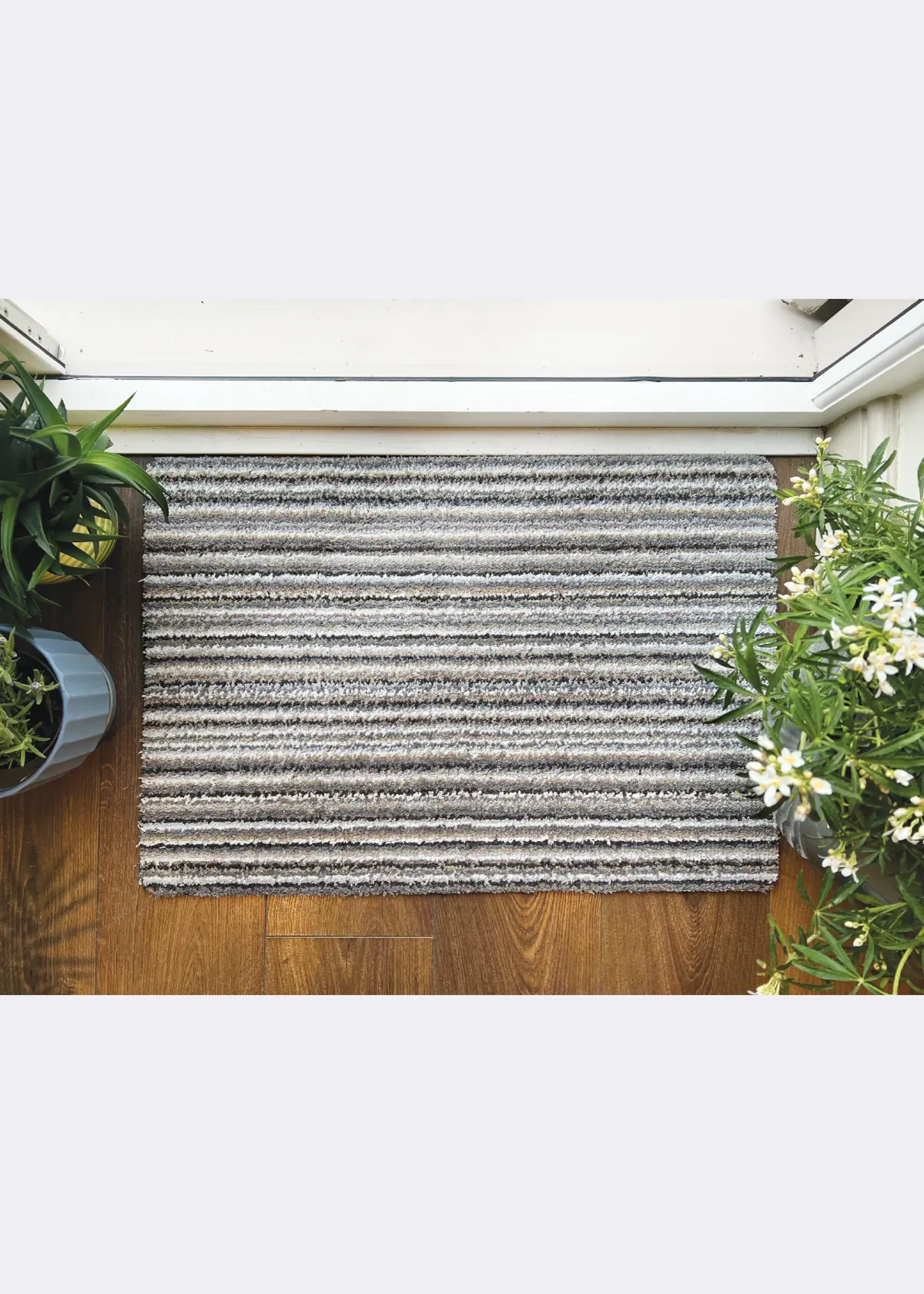 A photo of Dobbies Plain Portland Stone Stripe Indoor Mat 50x75cm