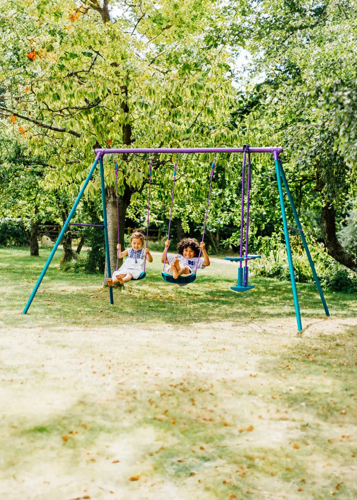 A photo of Plum® Jupiter® Double Swing & Glider Set Purple & Teal
