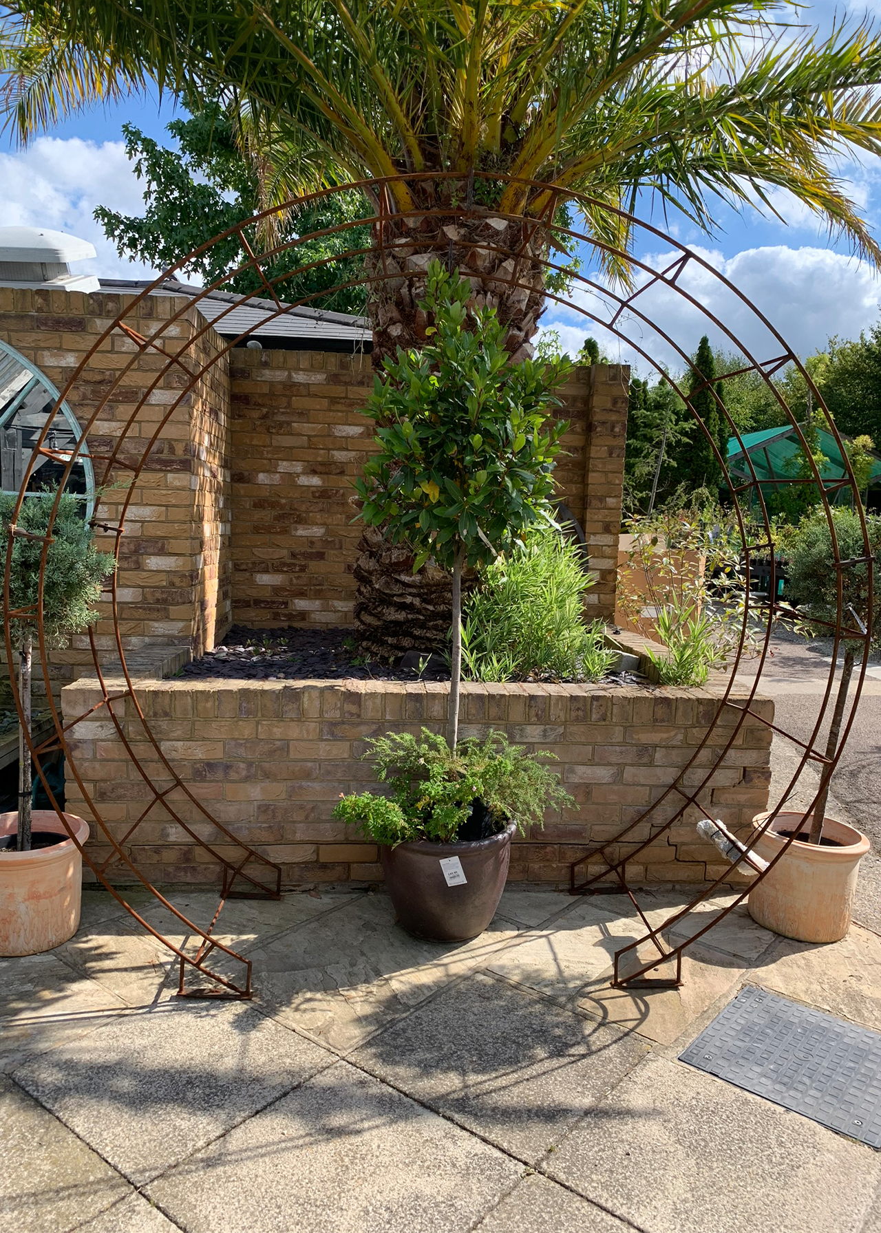 Round bare metal garden arch with ground spikes