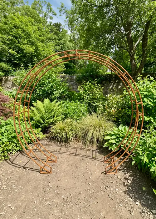 A photo of Round Bare Metal Garden Arch with Ground Spikes