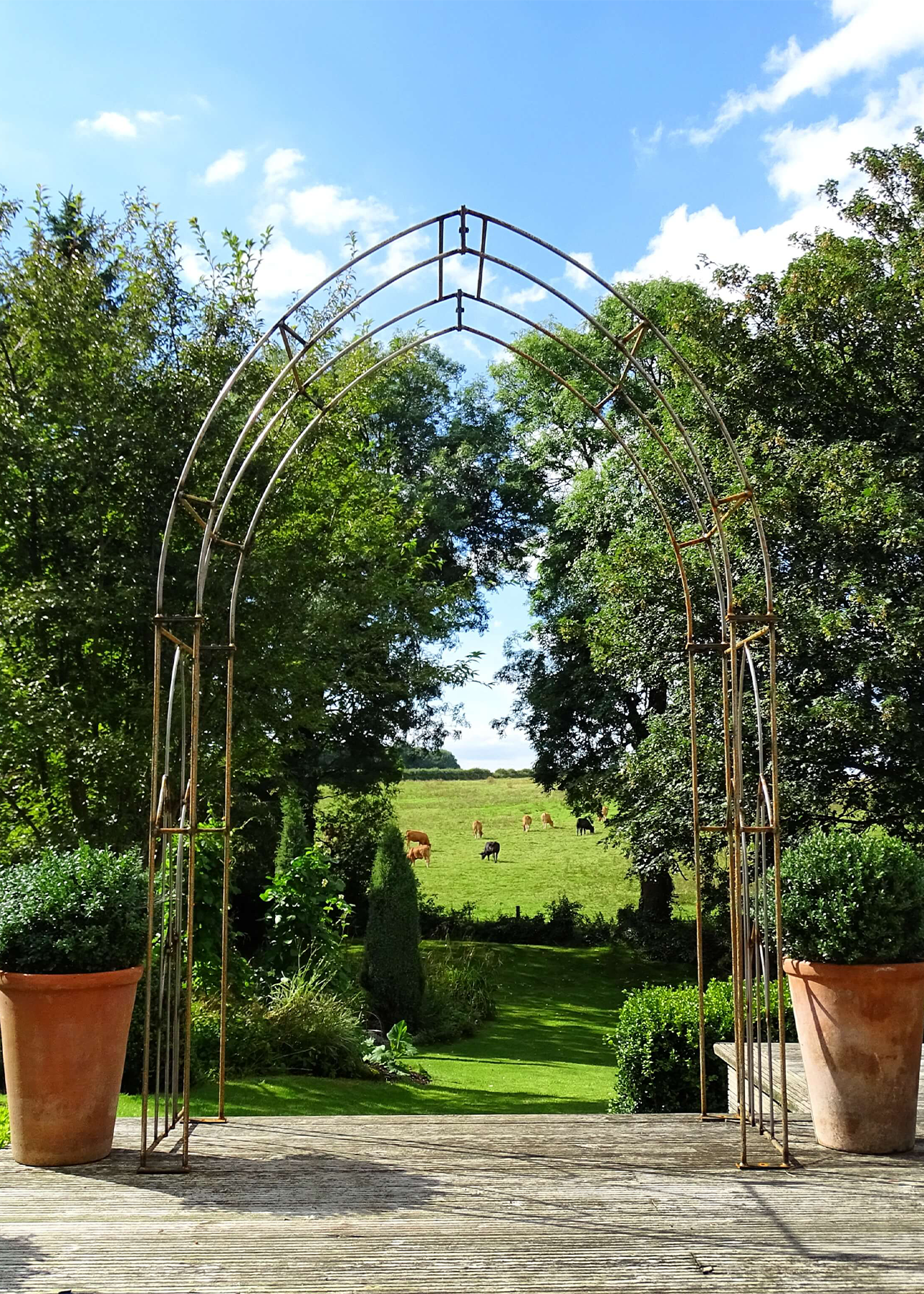 Gothic bare metal garden arch with ground spikes