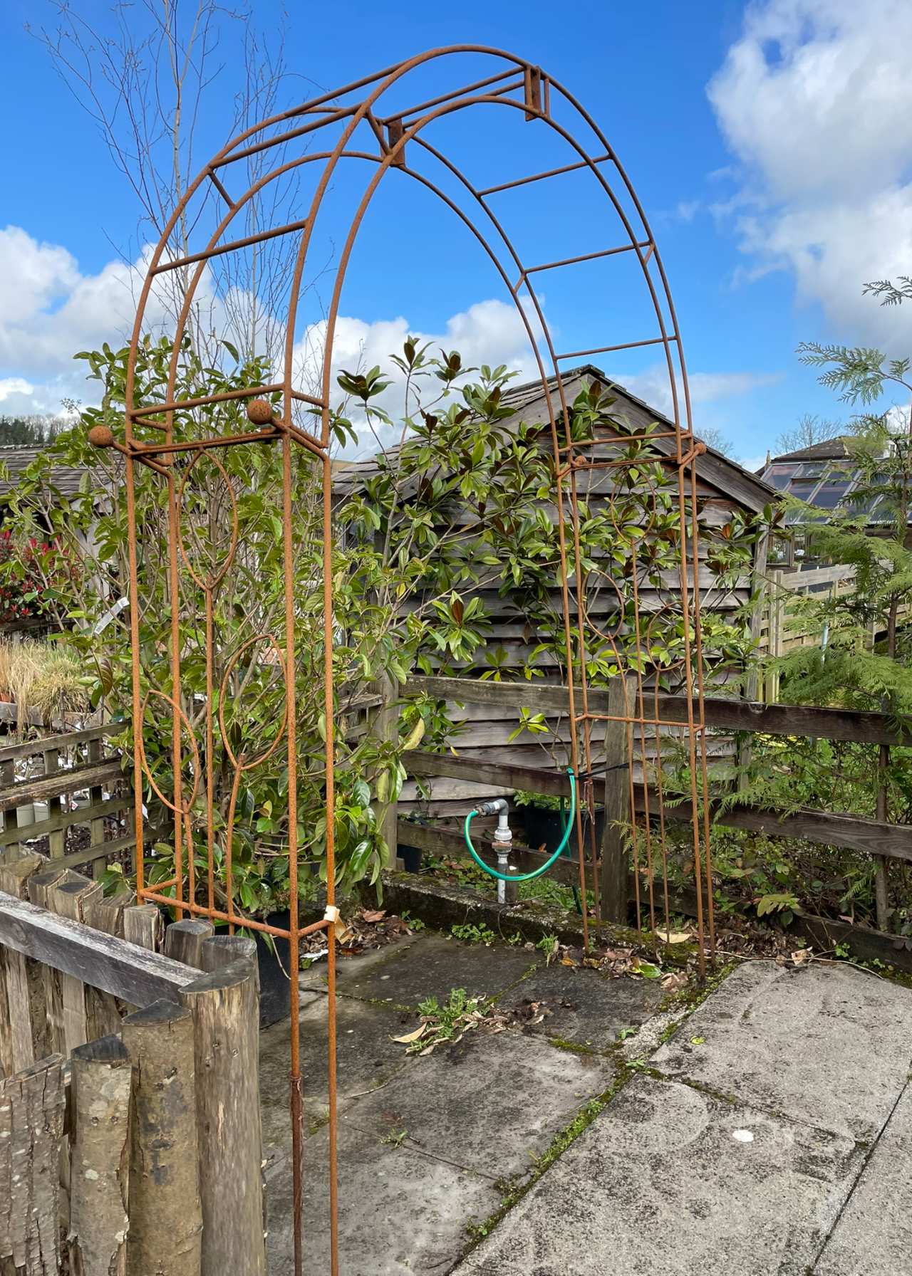 Flower traditional bare metal garden arch with ground spikes