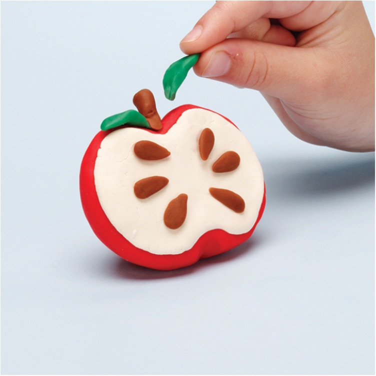 place pieces on the Play-Doh apple