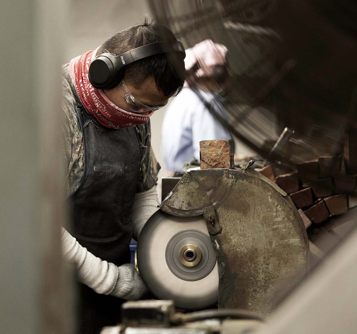 Employee working on the grinder
